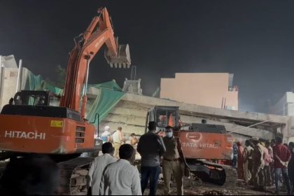 Collapsed building in Bhadrachalam with rescue teams on-site