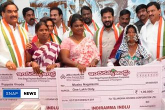 Government officials handing over the first cheques to beneficiaries of the Indiramma House Scheme in Telangana.
