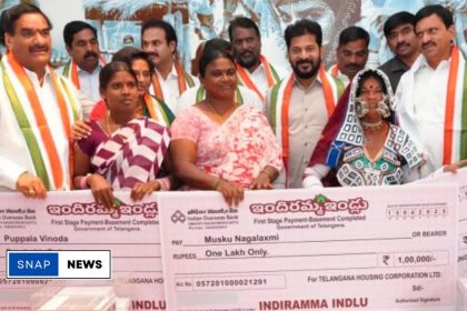 Government officials handing over the first cheques to beneficiaries of the Indiramma House Scheme in Telangana.
